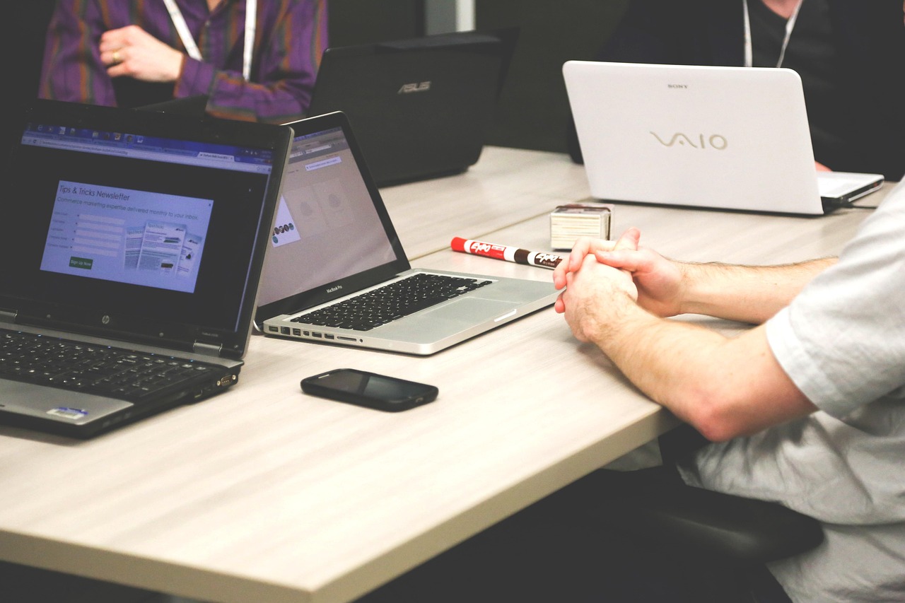 Two people working together at a laptop during a live build session